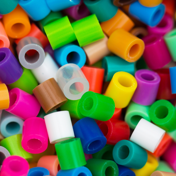 A pile of multicolored plastic perler beads. 