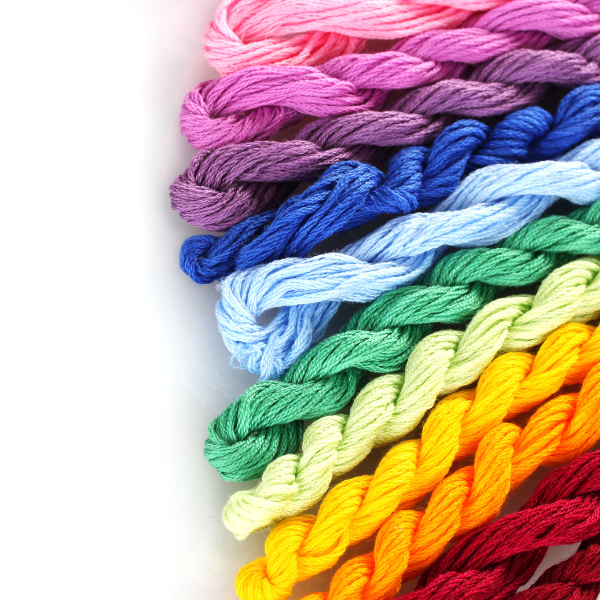 An array of yarn strands in rainbow colors